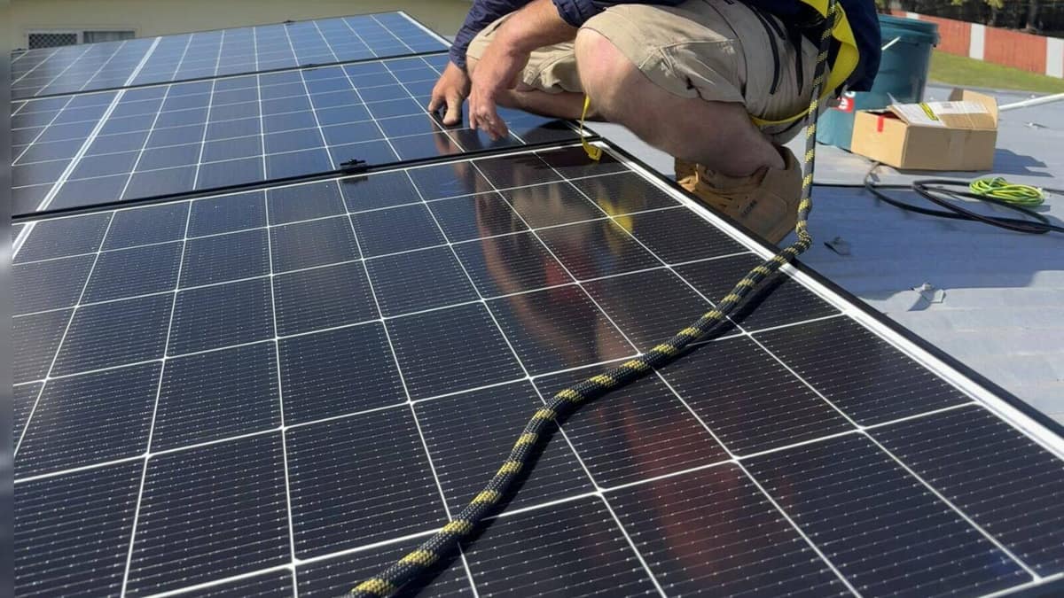 Close up of new solar panels being fitted on a Mackay roof