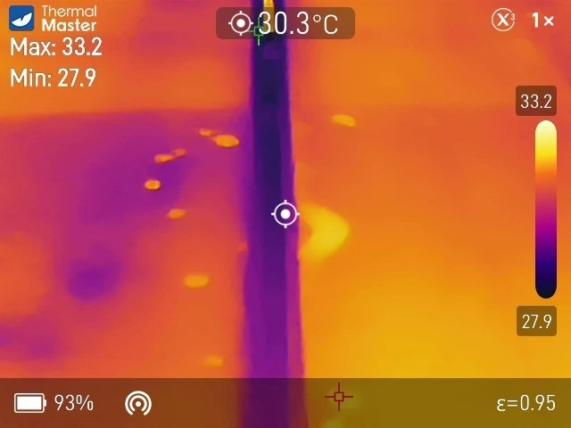 The same two panels on a thermal camera, with each spot showing as a warmer patch than the glass around it