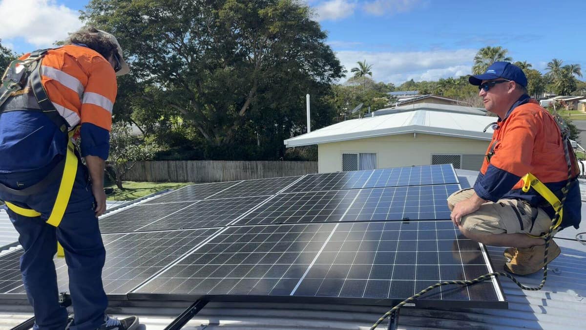 Rooftop solar array in coastal Queensland being cleaned with a water-fed pole