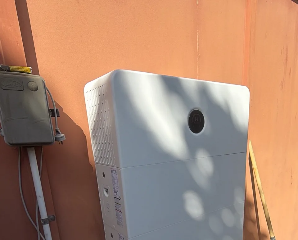 Home battery mounted on an exterior house wall in Mackay