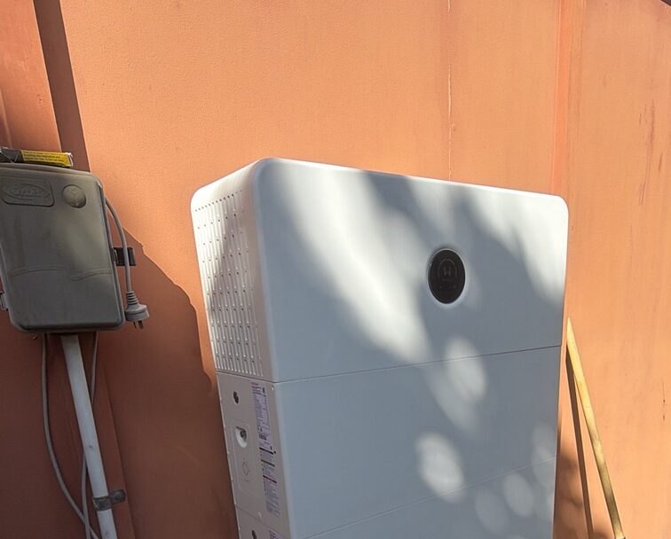 Home battery mounted on an exterior house wall in Mackay